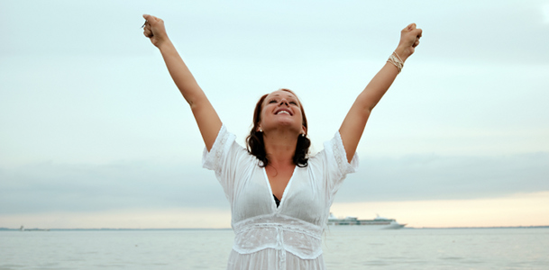 Happy Woman Raising Arms