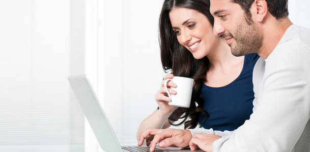 Happy Young Couple on Laptop