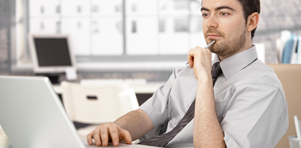 Intrigued Man Looking at Computer