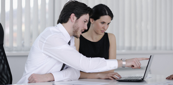 Two Workers Looking at Laptop