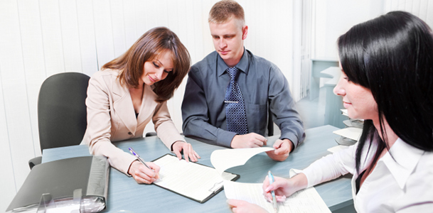 Couple Signing Papers